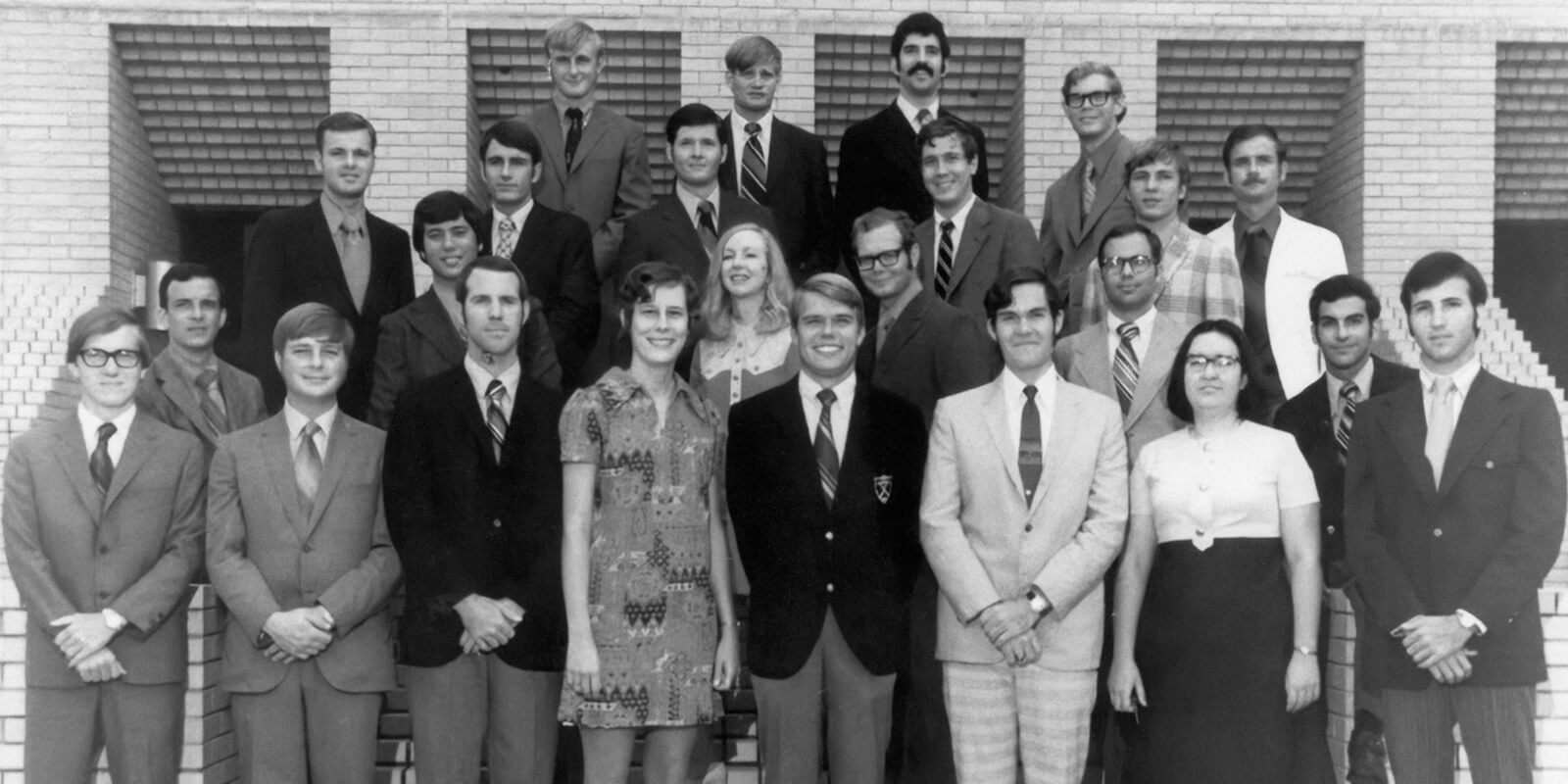 A black and white photo shows a group shot of the charter class